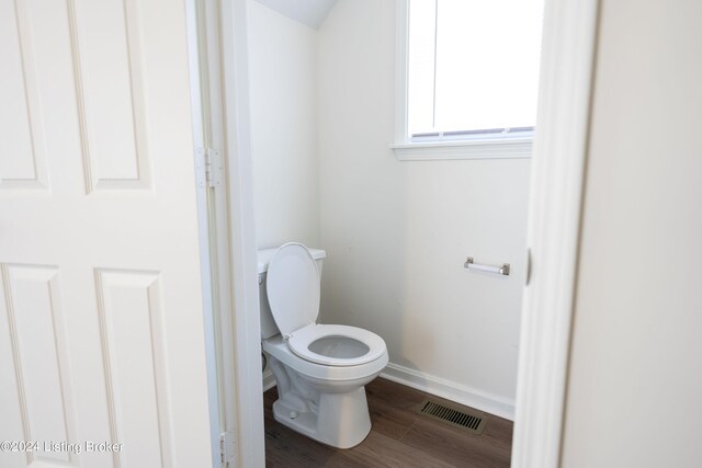 bathroom featuring hardwood / wood-style floors and toilet