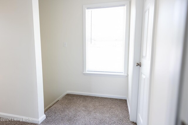 empty room with light colored carpet