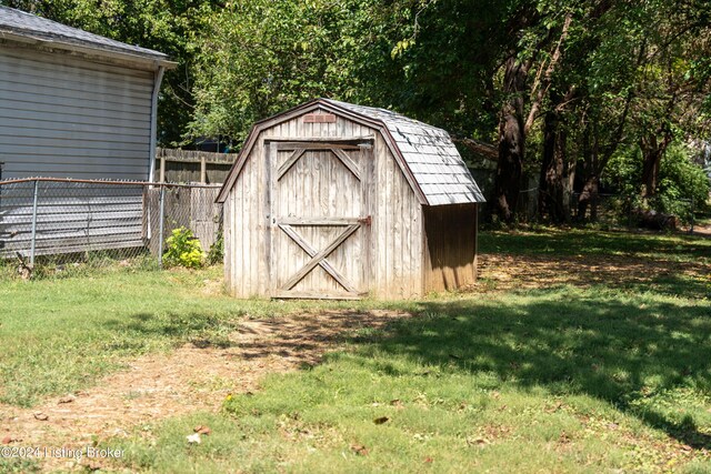 view of outbuilding featuring a lawn