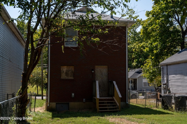 back of house with a lawn