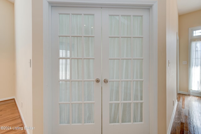 entryway with french doors and hardwood / wood-style floors