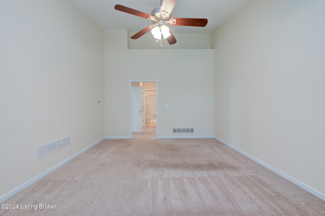 spare room featuring ceiling fan and light colored carpet