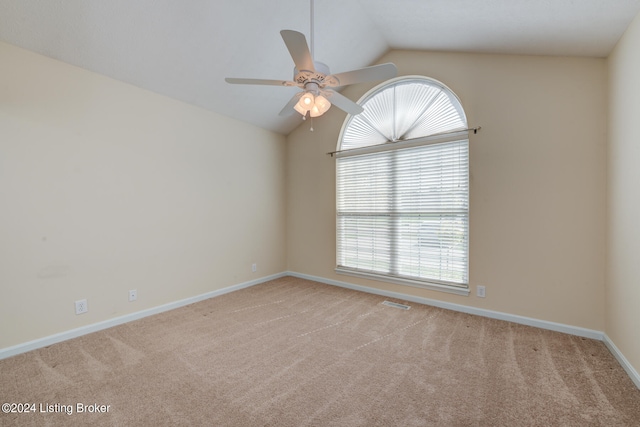 carpeted empty room featuring lofted ceiling and ceiling fan