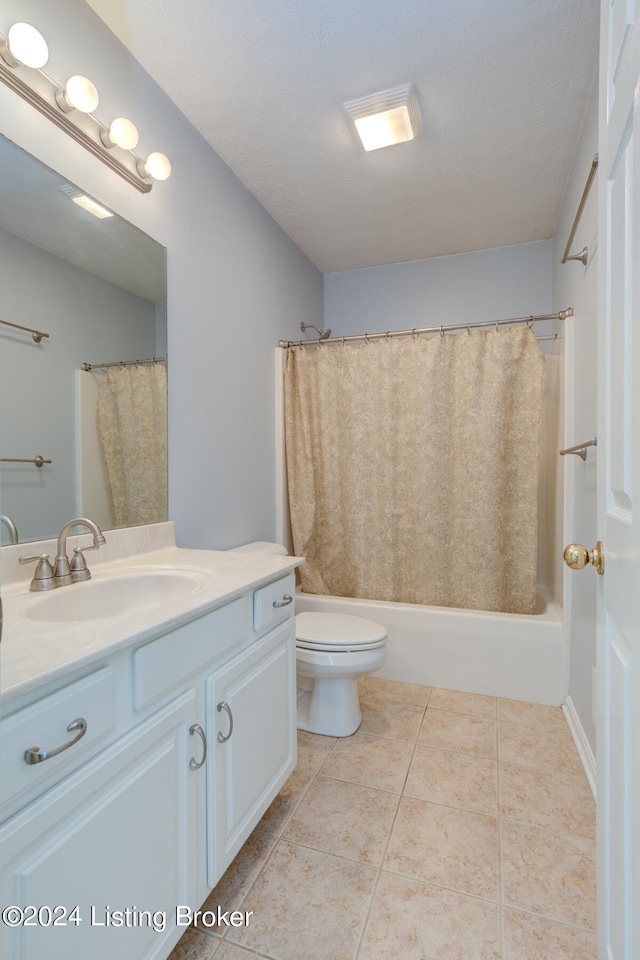 full bathroom featuring vanity, shower / bath combo, a textured ceiling, tile patterned floors, and toilet