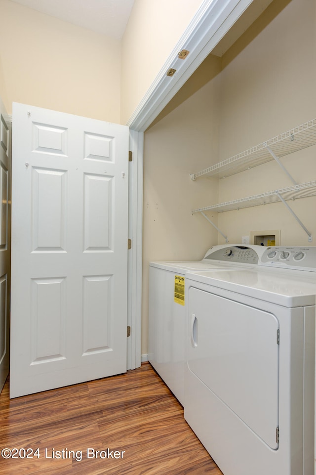 laundry room featuring light hardwood / wood-style floors and washer and dryer