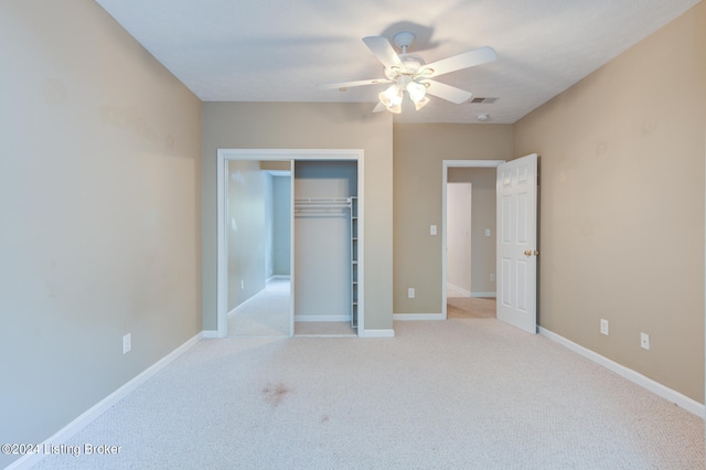 unfurnished bedroom featuring a closet, ceiling fan, and light colored carpet