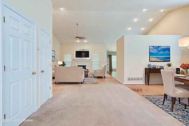 living room with light carpet and lofted ceiling