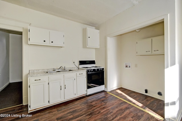 kitchen with white range with gas stovetop, dark hardwood / wood-style floors, sink, and white cabinets