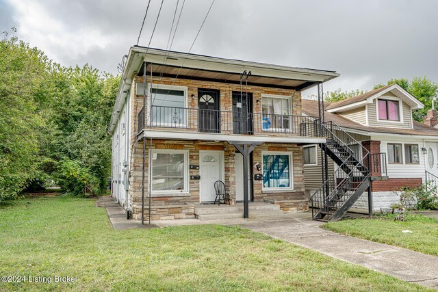 view of front of home with a balcony, a front lawn, and covered porch