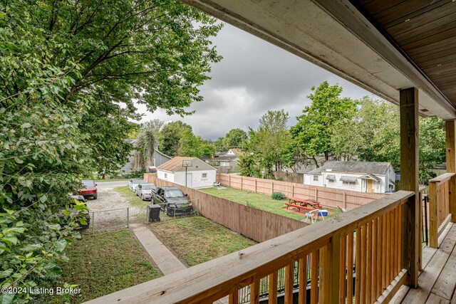 wooden terrace with a lawn