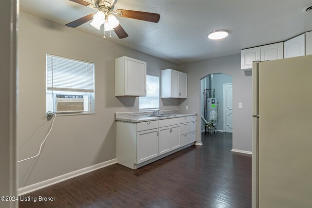 kitchen with white cabinetry, gas water heater, white fridge, ceiling fan, and sink