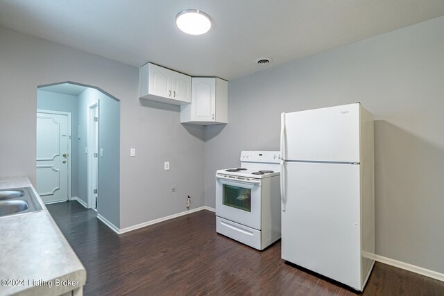 kitchen with white appliances, dark hardwood / wood-style flooring, and white cabinets