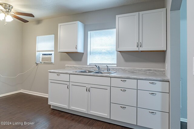 kitchen featuring dark wood-type flooring, sink, white cabinets, cooling unit, and ceiling fan