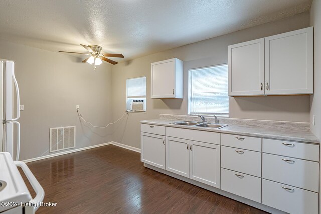 kitchen with ceiling fan, white refrigerator, sink, white cabinetry, and dark hardwood / wood-style floors