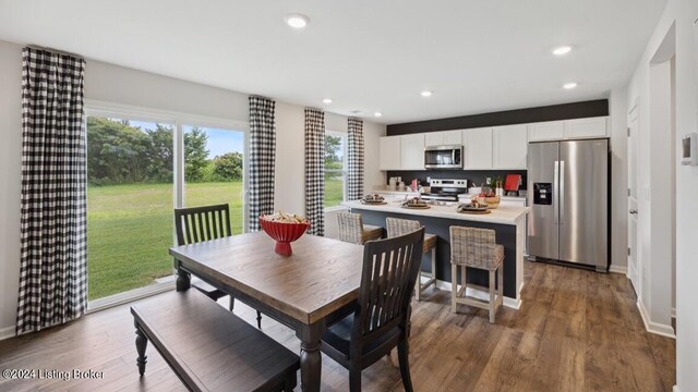 dining space with dark hardwood / wood-style floors