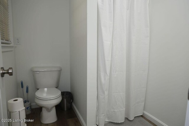 bathroom featuring wood-type flooring and toilet