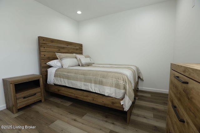 bedroom with dark hardwood / wood-style flooring