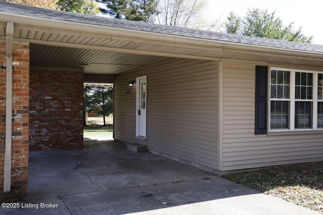 property entrance with a carport