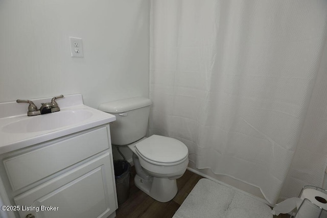 bathroom featuring vanity, hardwood / wood-style floors, and toilet