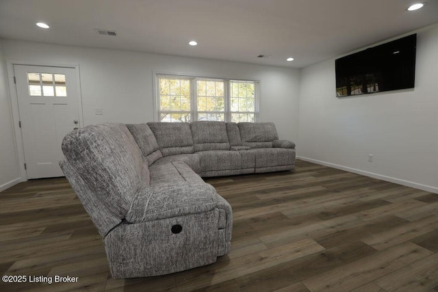 living room with dark hardwood / wood-style flooring