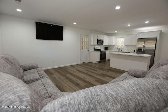 living room with dark hardwood / wood-style flooring and sink