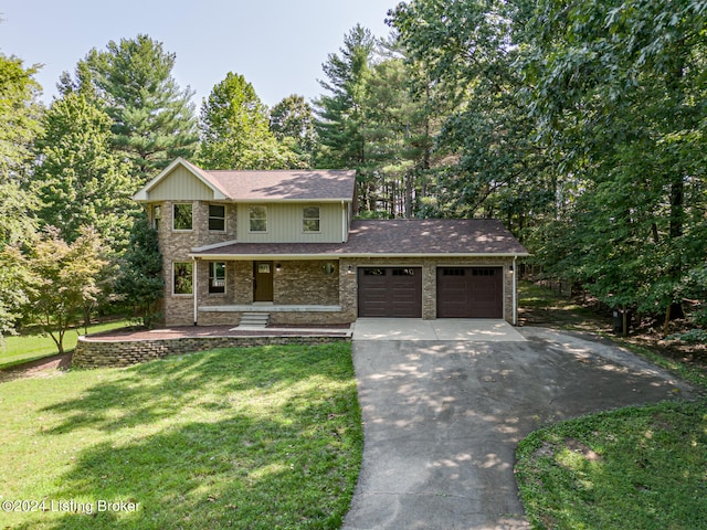 view of front property featuring a front lawn, covered porch, and a garage