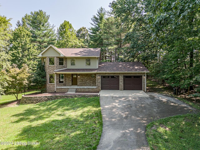 2656 Doe Valley Pkwy, Brandenburg, KY 40108 - view of front of house featuring concrete driveway, roof with shingles, a front lawn, covered porch, and a garage