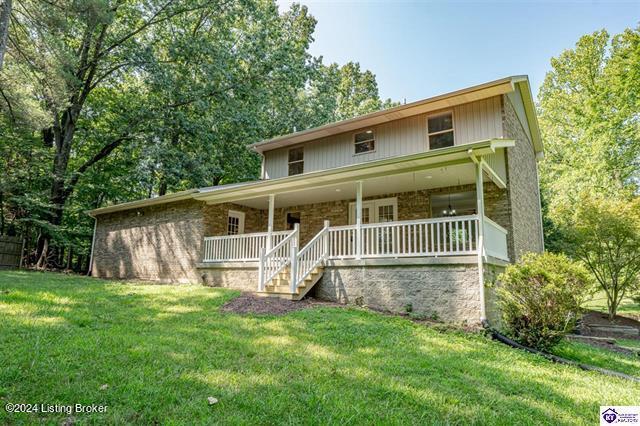 view of front of property with a front yard and a porch