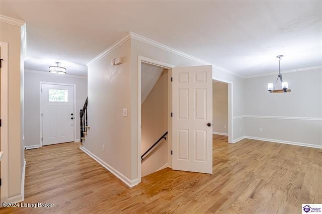 entrance foyer featuring light hardwood / wood-style flooring and ornamental molding