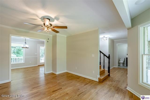 2656 Doe Valley Pkwy, Brandenburg, KY 40108 - empty room featuring light wood finished floors, ceiling fan with notable chandelier, crown molding, and baseboards