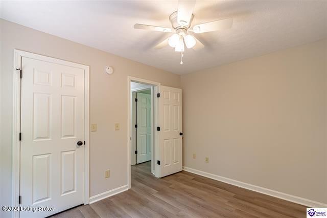 unfurnished bedroom featuring light wood-type flooring and ceiling fan