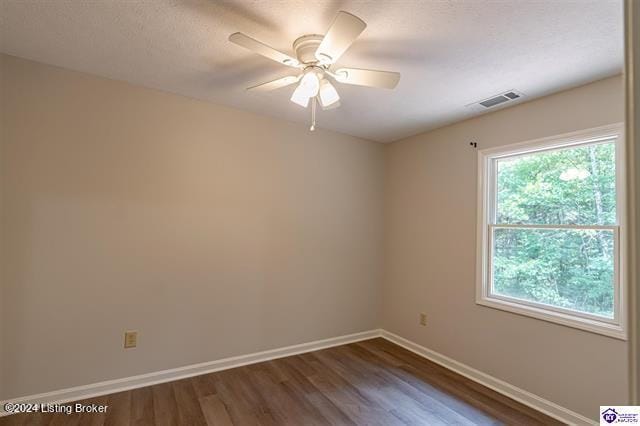 unfurnished room featuring ceiling fan and dark wood-type flooring