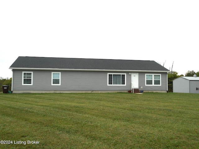 rear view of house featuring a lawn