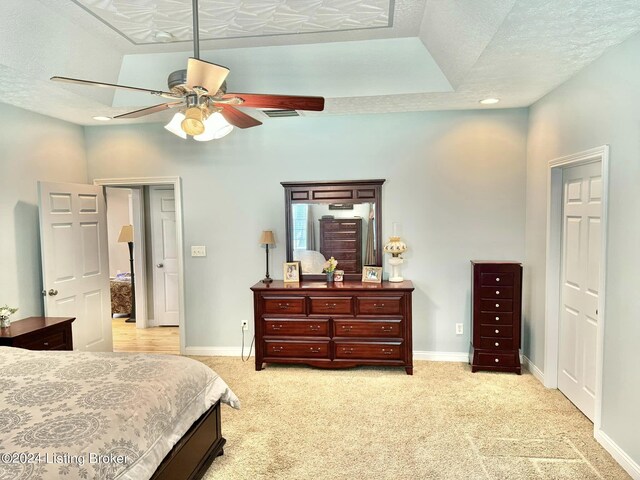 carpeted bedroom featuring a textured ceiling and ceiling fan