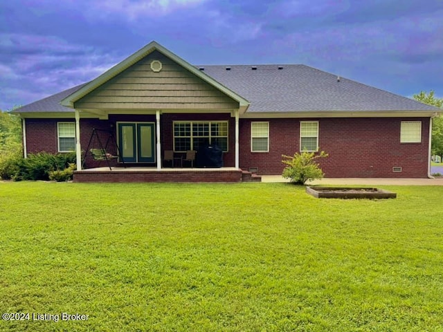 rear view of house with a yard