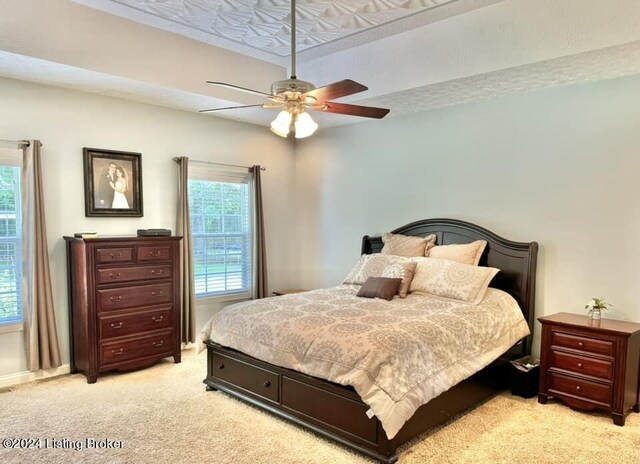 bedroom with light carpet and ceiling fan