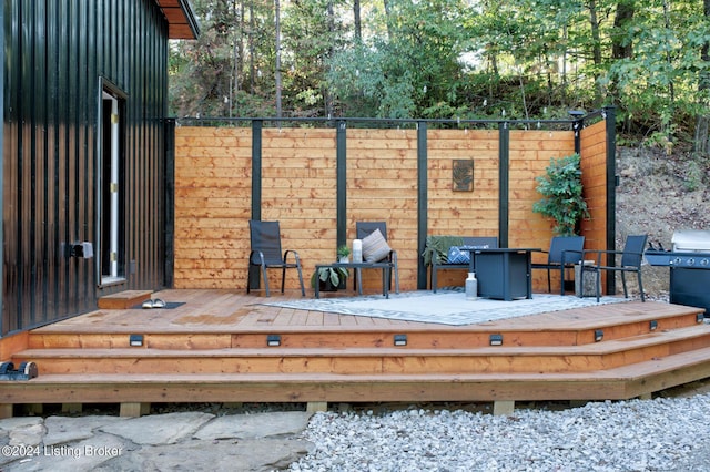 wooden terrace featuring fence