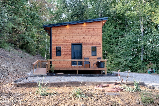 exterior space featuring a wooded view