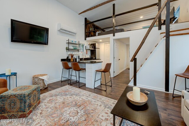 living room with an AC wall unit and dark hardwood / wood-style floors