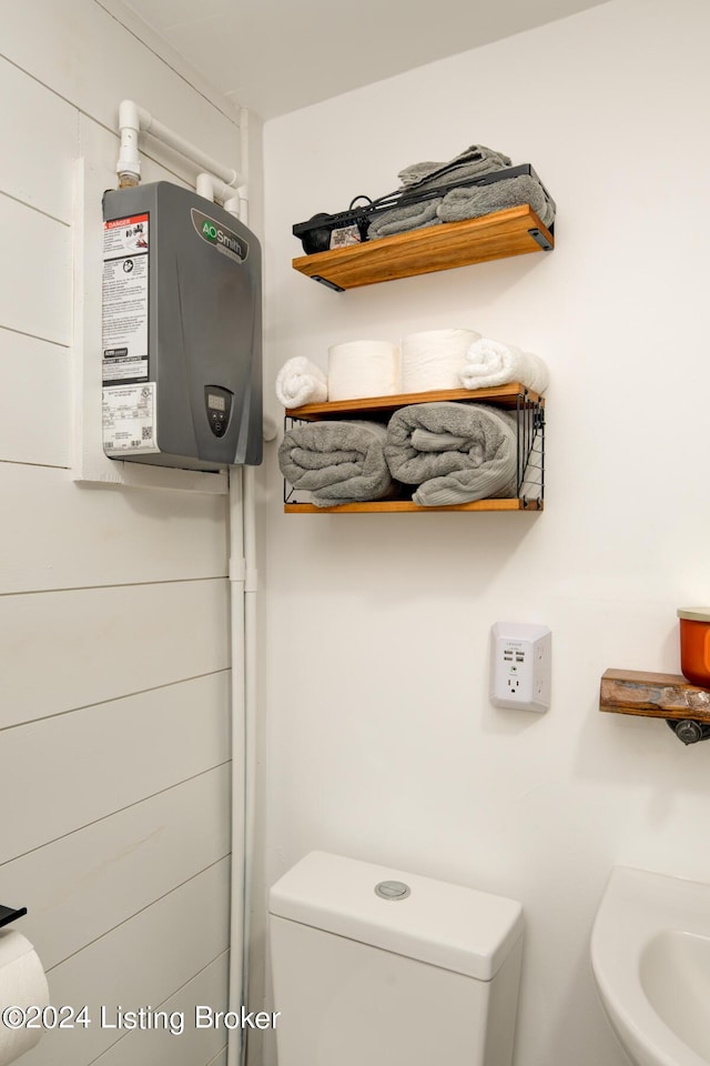 half bath with water heater and toilet