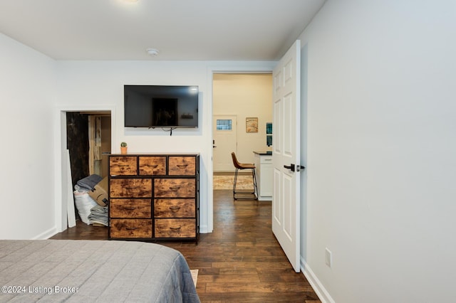 bedroom featuring dark wood finished floors and baseboards