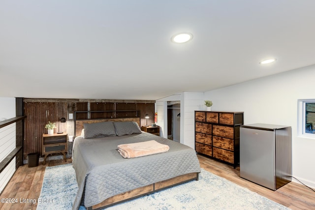 bedroom featuring light wood-style floors, a fireplace, and recessed lighting