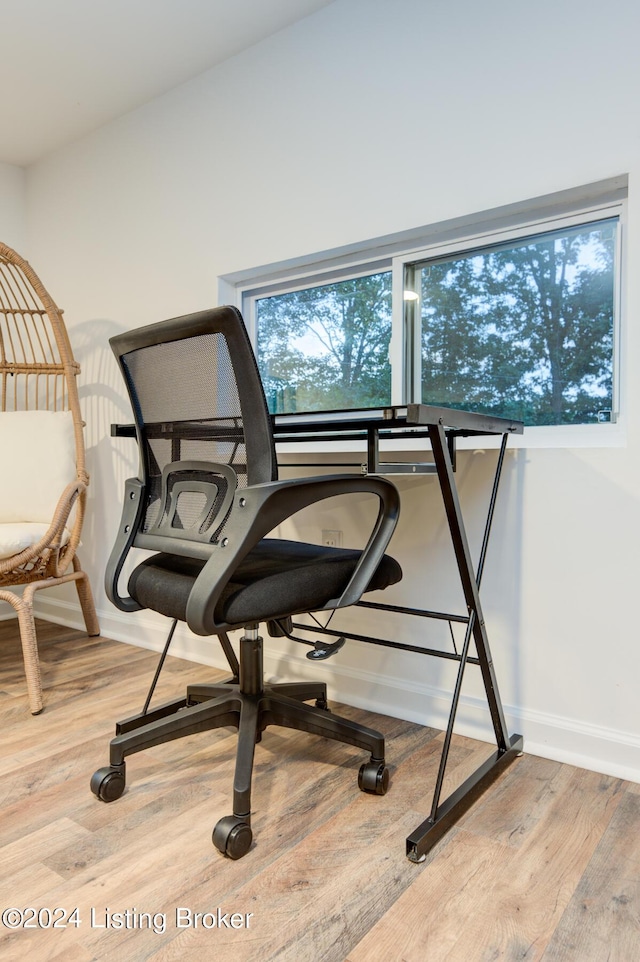 interior space with baseboards and wood finished floors