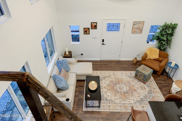 living area with baseboards and wood finished floors