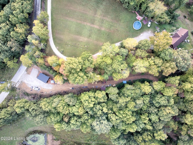 birds eye view of property featuring a wooded view