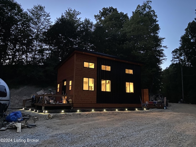 view of side of property with board and batten siding and a porch