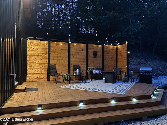 deck at night with area for grilling