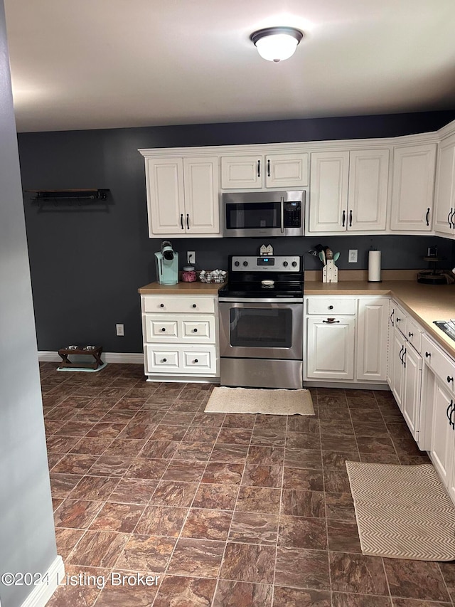 kitchen with stainless steel appliances and white cabinets