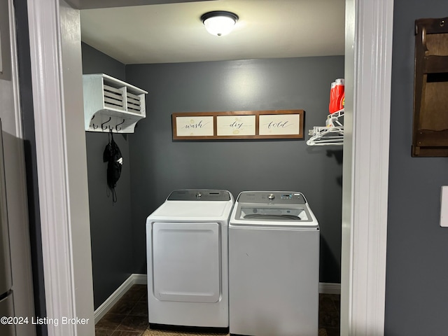 washroom with dark tile patterned floors and separate washer and dryer