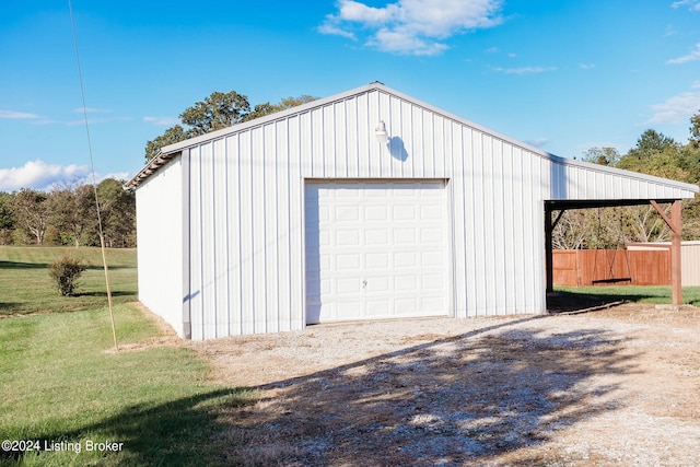 garage featuring a lawn and wooden walls